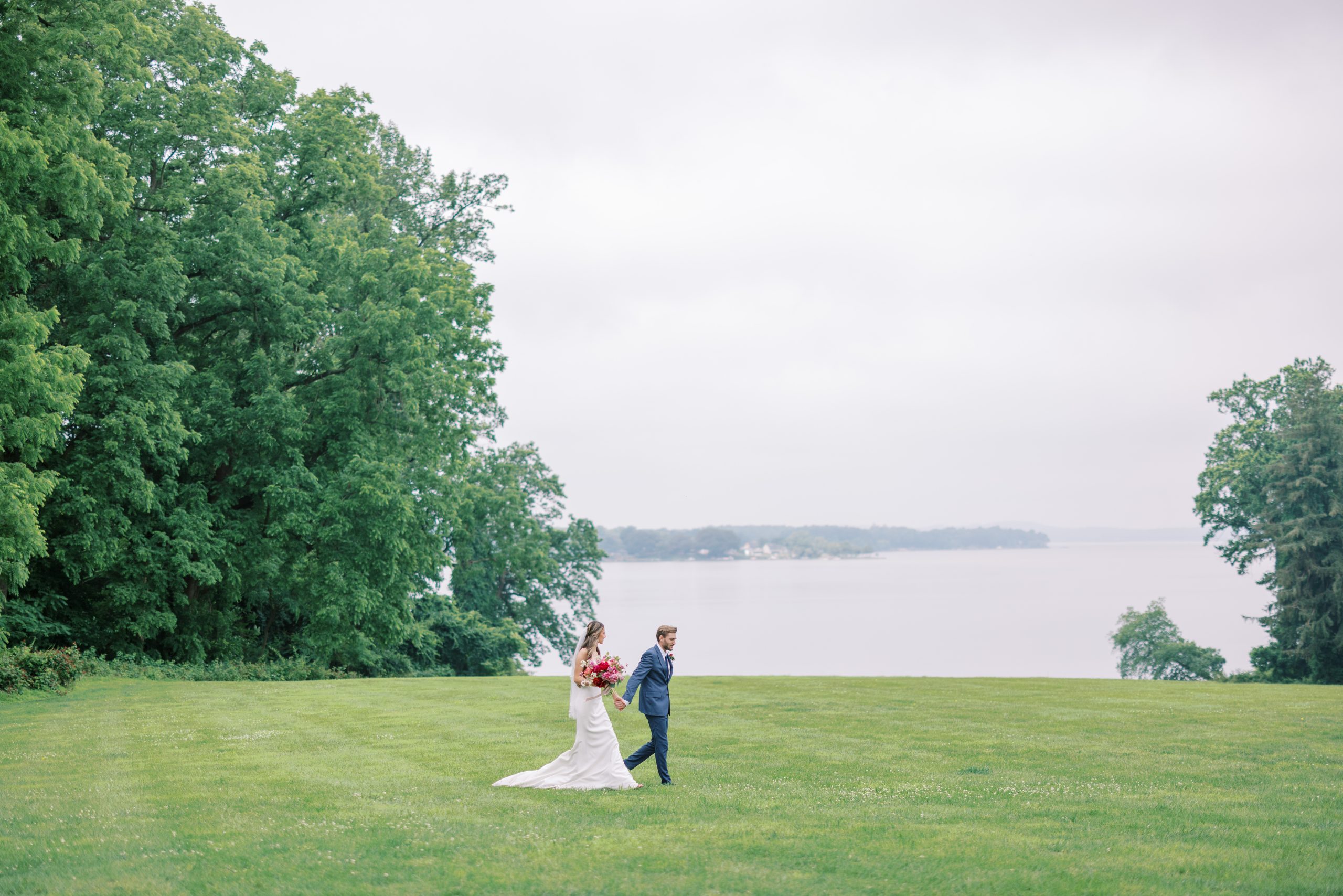 A married couple walking on the lawns of Bohemia Manor Farm.